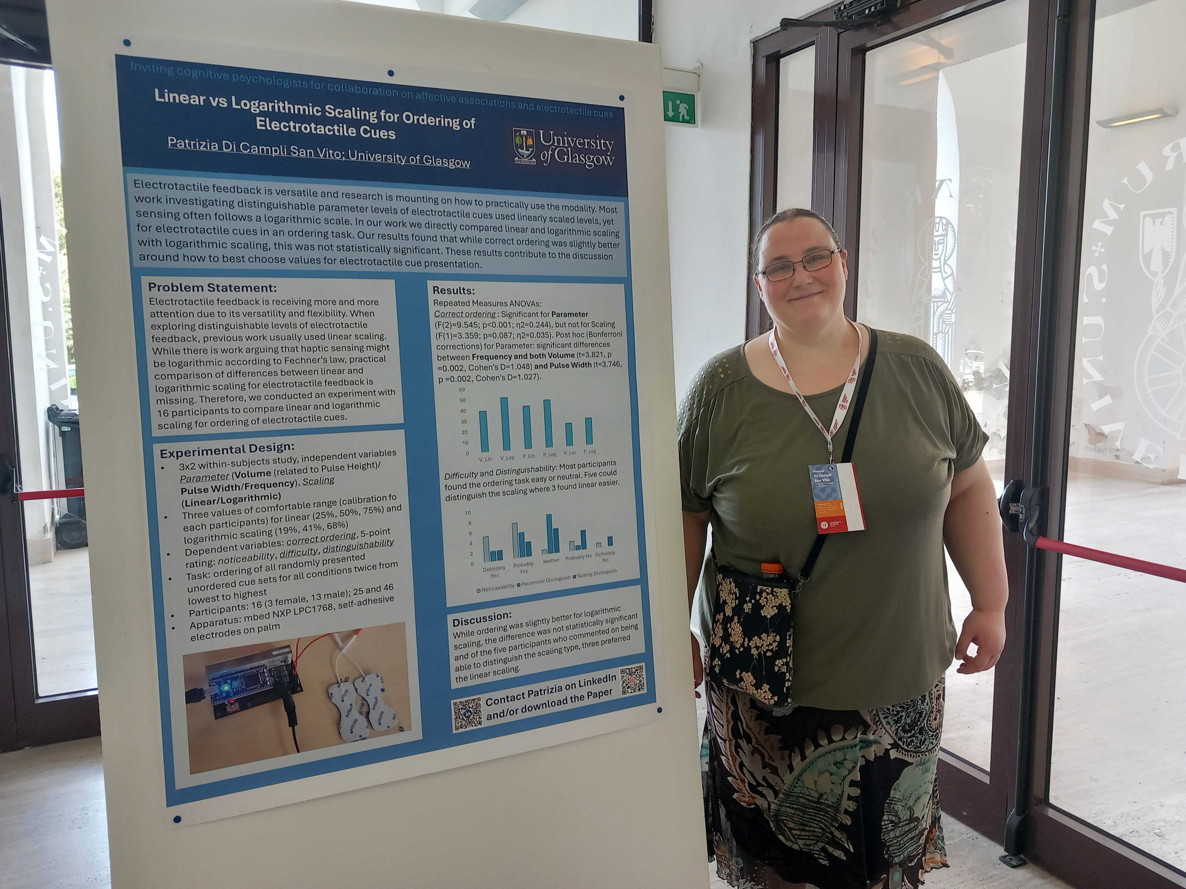 Patrizia standing next to a poster